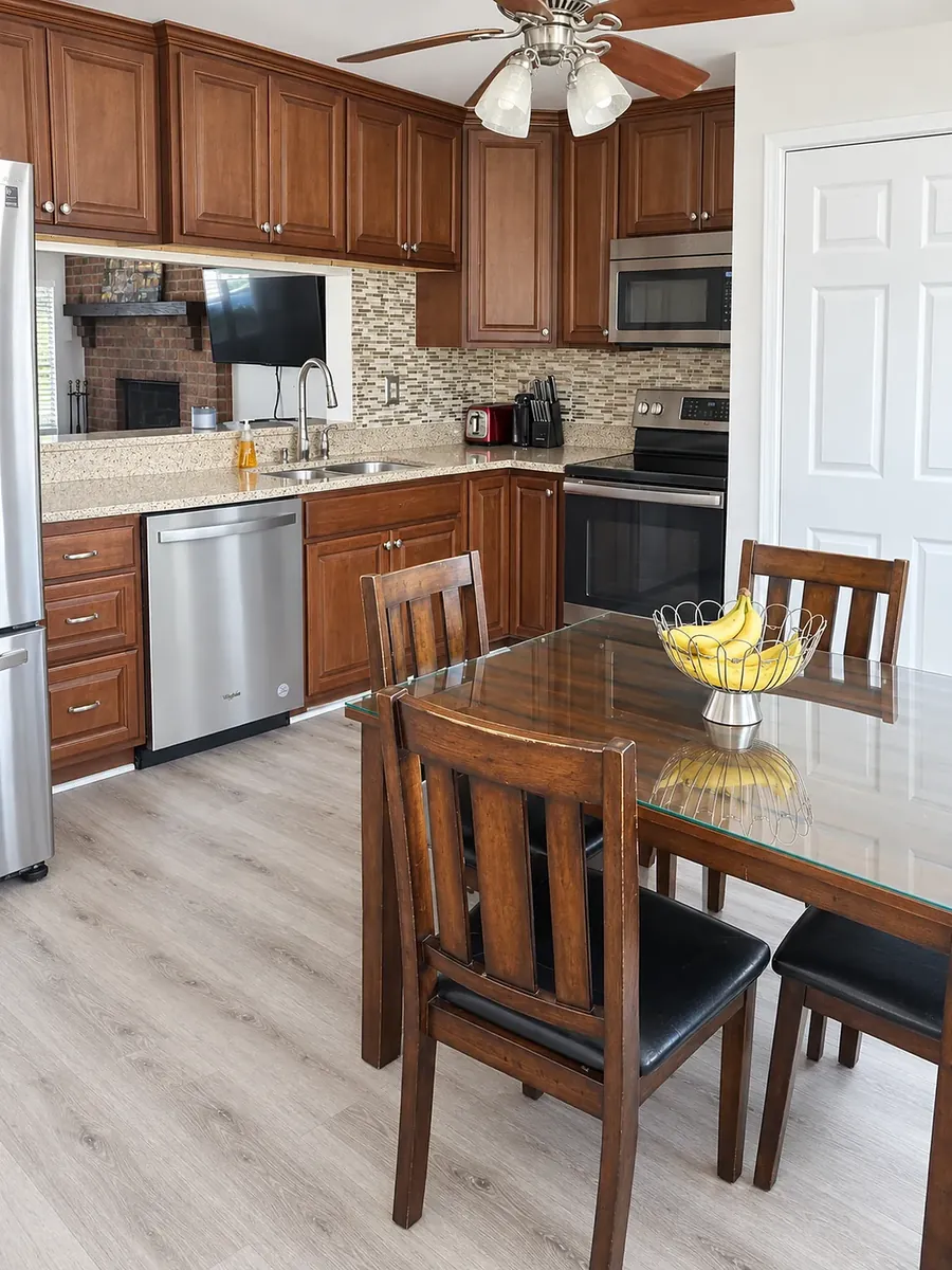 The same kitchen on their site: the same cabinets, table, chairs and bowl of bananas, shot level with brighter, even light.
